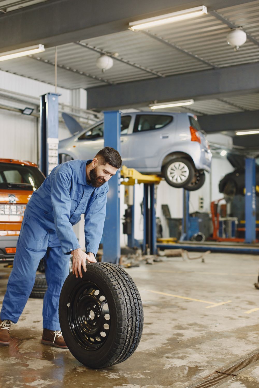 Technician mounting a tire during a seasonal tire swap